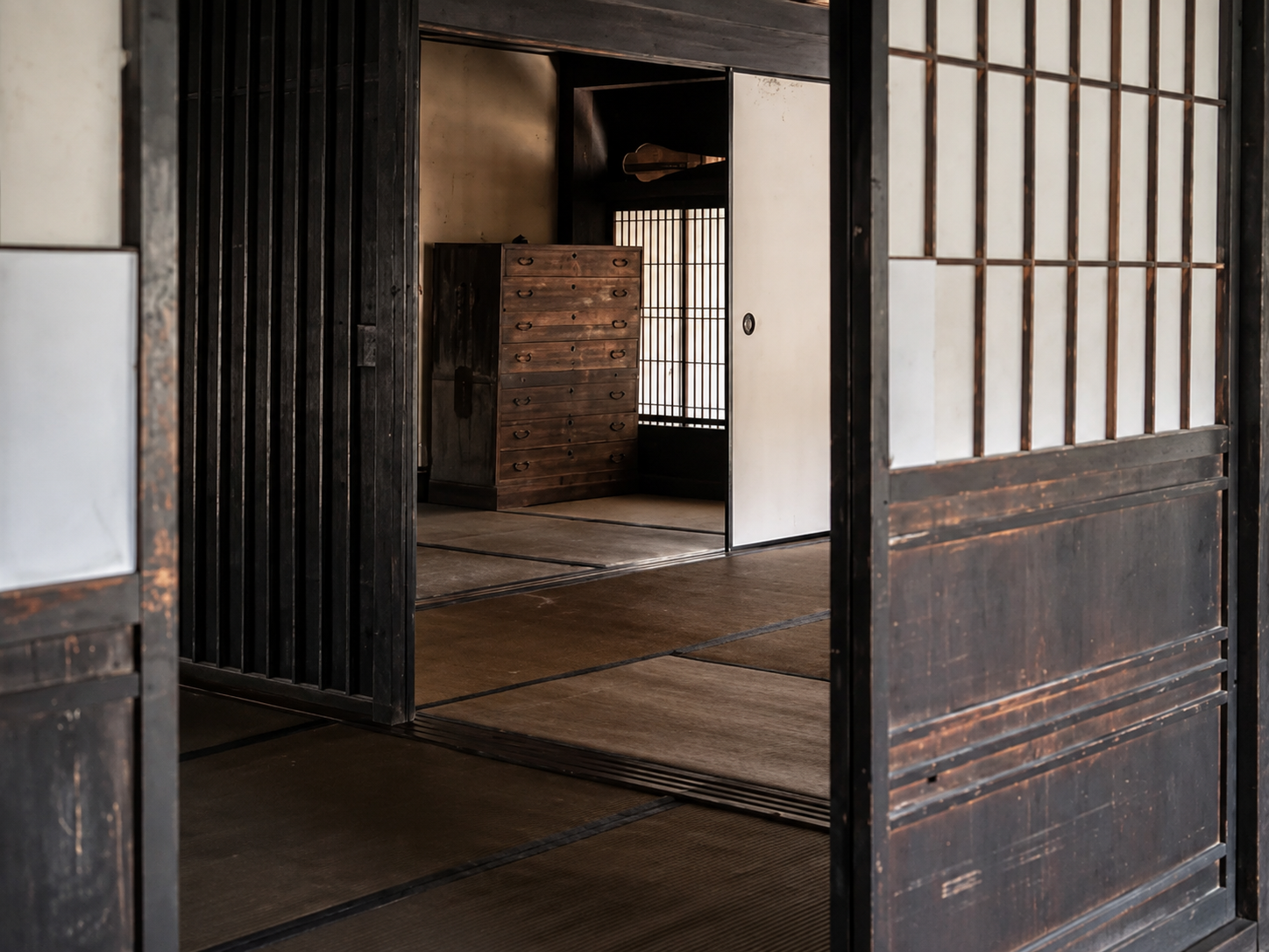 Natural linen seating, aged wood and handmade pottery in a quiet wabi-sabi interior