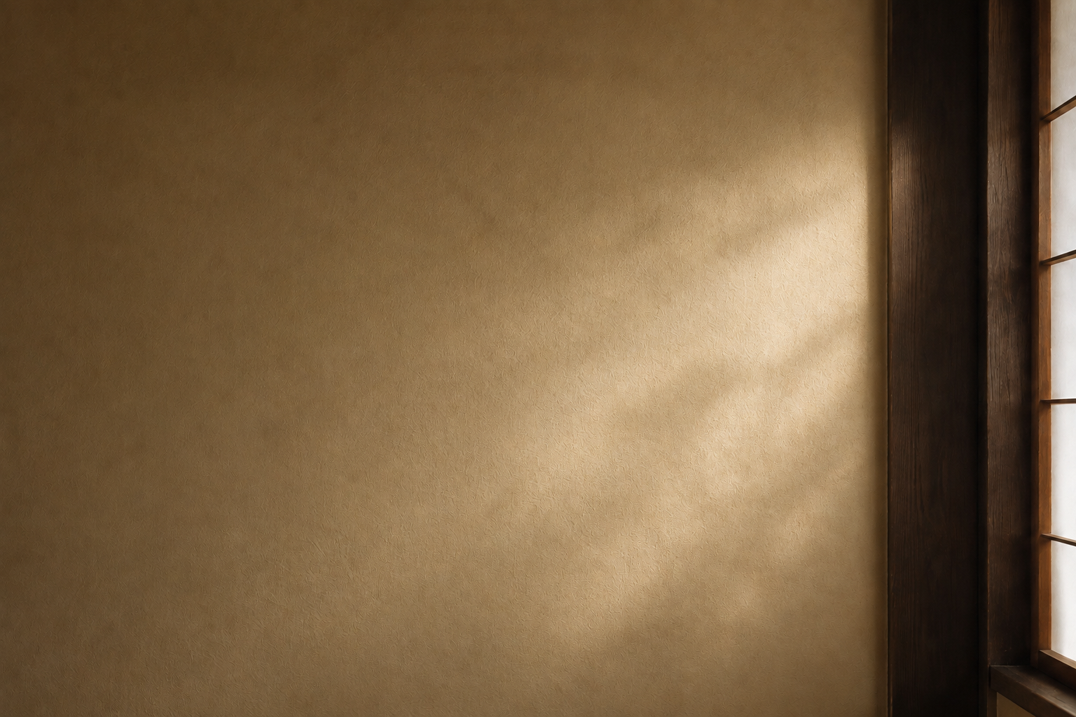 A narrow ray of sunlight on a textured plaster wall